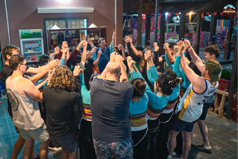 Travelers joining traditional cultural and artistic activities with local people in a Vietnamese ethnic village